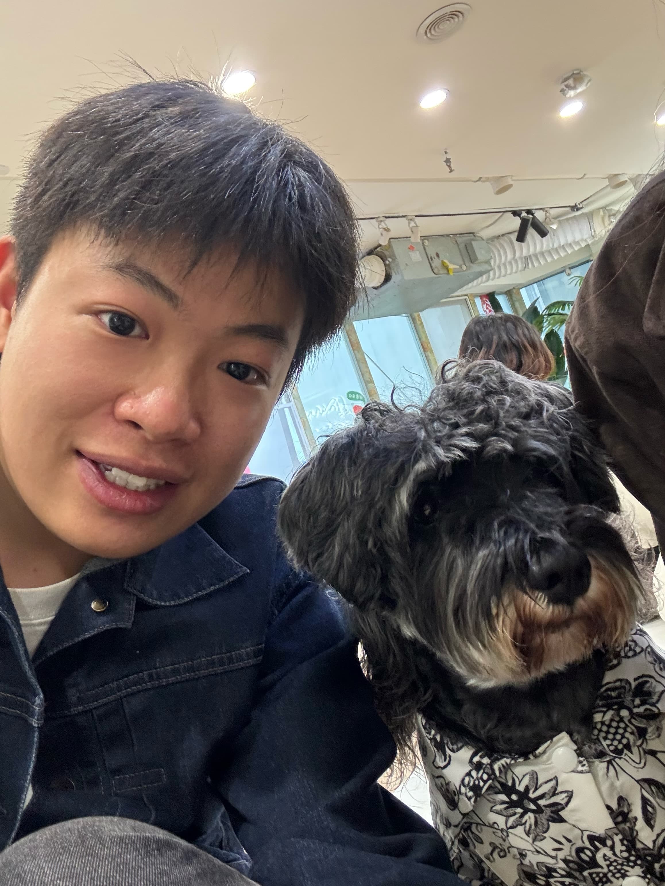 Howard taking a selfie with a dog