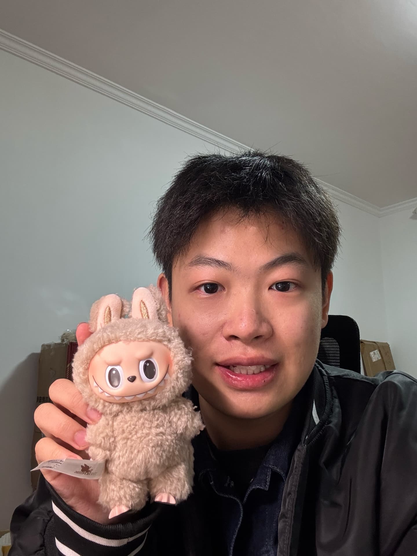 Howard holding a plush character